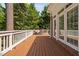 Wooden deck with seating area offers picturesque views of the surrounding lush greenery and brick home at 72103 Moseley, Chapel Hill, NC 27517