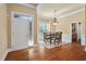 Open floor plan view features the front door, dining room with hardwood floors, and a white front door at 72103 Moseley, Chapel Hill, NC 27517