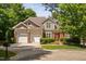 Charming home featuring a three-car garage and beautifully landscaped front yard at 72103 Moseley, Chapel Hill, NC 27517