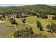 Aerial view of a golf course with a pond and a clubhouse in a scenic, wooded area at 72103 Moseley, Chapel Hill, NC 27517