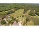 An aerial view shows a golf course with a lake, sand traps and well-manicured putting greens at 72103 Moseley, Chapel Hill, NC 27517