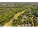 Aerial view of a golf course with mature trees and luxury homes in a beautiful setting at 72103 Moseley, Chapel Hill, NC 27517