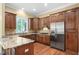 Kitchen features granite countertops, wooden cabinetry, stainless steel appliances, and hardwood floors at 72103 Moseley, Chapel Hill, NC 27517