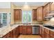 Kitchen features granite countertops, wooden cabinetry, stainless steel appliances, and a window at 72103 Moseley, Chapel Hill, NC 27517
