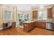 Open kitchen features granite countertops, wooden cabinetry, stainless steel appliances, and hardwood floors at 72103 Moseley, Chapel Hill, NC 27517