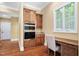 Kitchen area features a built-in oven, wooden cabinetry, hardwood floors, granite countertops, and a window at 72103 Moseley, Chapel Hill, NC 27517