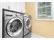 Bright laundry room featuring a modern washer and dryer with a window providing natural light at 72103 Moseley, Chapel Hill, NC 27517
