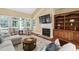 Cozy living room with fireplace, built-in shelving, and a view of the backyard at 72103 Moseley, Chapel Hill, NC 27517