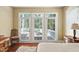 Comfortable main bedroom featuring wood floors, balcony access, and a cozy rug at 72103 Moseley, Chapel Hill, NC 27517