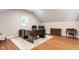Well-lit office space with hardwood floors, a large desk, and built-in storage for organization at 72103 Moseley, Chapel Hill, NC 27517