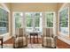 Cozy sitting area with two striped armchairs facing a private backyard at 72103 Moseley, Chapel Hill, NC 27517