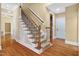 Elegant staircase with carpet runner, wood railing, and wrought iron spindles, adds character at 72103 Moseley, Chapel Hill, NC 27517