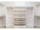 Well-organized walk-in closet with shelving and rods, providing plenty of storage space at 72103 Moseley, Chapel Hill, NC 27517