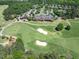 An aerial view of a golf course and country club with beautiful landscaping at 7616 Hasentree Way, Wake Forest, NC 27587