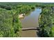 Aerial view of the lake, showcasing the bridge and surrounding natural landscape at 7616 Hasentree Way, Wake Forest, NC 27587