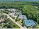 Overhead view of tennis courts near clubhouse in a serene, wooded setting, perfect for recreation at 7616 Hasentree Way, Wake Forest, NC 27587