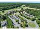 Aerial view of the clubhouse, golf course, parking area, and meticulously landscaped grounds at 7616 Hasentree Way, Wake Forest, NC 27587