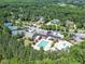 Aerial view of pools, tennis courts, and clubhouse surrounded by lush greenery and well-maintained grounds at 7616 Hasentree Way, Wake Forest, NC 27587