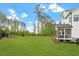 Expansive backyard with lush green lawn and a screened porch perfect for relaxing at 7616 Hasentree Way, Wake Forest, NC 27587