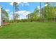 Expansive backyard features lush lawn and mature trees, offering privacy at 7616 Hasentree Way, Wake Forest, NC 27587