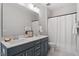 Bathroom with double sinks, white countertops, and white shower curtain at 7616 Hasentree Way, Wake Forest, NC 27587