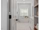 Bright bathroom with large soaking tub, white cabinets and white marble tile flooring at 7616 Hasentree Way, Wake Forest, NC 27587