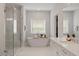 Bright bathroom with soaking tub, glass shower, and double vanity at 7616 Hasentree Way, Wake Forest, NC 27587