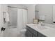 Bathroom features a marble tiled tub/shower combination and a vanity with ample counter space at 7616 Hasentree Way, Wake Forest, NC 27587