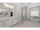 A full bathroom with separate tub, glass shower and dual vanity with marble countertops at 7616 Hasentree Way, Wake Forest, NC 27587