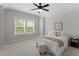 Bright bedroom with large windows, carpeting, and an ensuite bath at 7616 Hasentree Way, Wake Forest, NC 27587