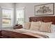 A closer shot of the primary bedroom showcasing the natural light and beautiful artwork at 7616 Hasentree Way, Wake Forest, NC 27587