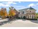 Charming building exterior featuring stone accents, a turret, and large windows for natural light at 7616 Hasentree Way, Wake Forest, NC 27587