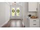 Bright entryway featuring wood floors, double front doors, and stylish decor, creating a welcoming ambiance at 7616 Hasentree Way, Wake Forest, NC 27587