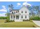 Elegant two-story home with a welcoming front porch and manicured lawn at 7616 Hasentree Way, Wake Forest, NC 27587