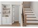 Hallway with hardwood floors features a staircase and access to rooms at 7616 Hasentree Way, Wake Forest, NC 27587