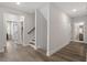 Spacious hallway leads to bedrooms and bathrooms and features hardwood flooring at 7616 Hasentree Way, Wake Forest, NC 27587