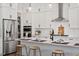 Bright kitchen featuring stainless steel appliances, white cabinets, and a spacious quartz countertop island with seating at 7616 Hasentree Way, Wake Forest, NC 27587