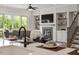 Cozy living room with fireplace, built-ins, and easy access to outdoor patio at 7616 Hasentree Way, Wake Forest, NC 27587
