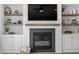 Living room features a fireplace with built-in shelving and a large flat-screen TV at 7616 Hasentree Way, Wake Forest, NC 27587