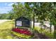 Gathering activity center sign highlights pools, tennis courts, and fitness center amidst colorful landscaping at 7616 Hasentree Way, Wake Forest, NC 27587
