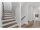 Beautiful staircase with wood railings and white trim, leading to the upper level at 7616 Hasentree Way, Wake Forest, NC 27587