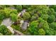 An aerial view of a home surrounded by green trees and other houses at 804 Warwick Ct, Burlington, NC 27215