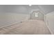 Carpeted attic area with neutral walls, a small window, and recessed lighting at 804 Warwick Ct, Burlington, NC 27215