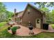 Inviting backyard patio area, showcasing a brick fire pit, grill, and access to deck at 804 Warwick Ct, Burlington, NC 27215