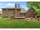 Spacious backyard featuring a wooden deck, brick chimney, lush green lawn, and privacy at 804 Warwick Ct, Burlington, NC 27215