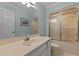Bathroom with a sink, mirror, toilet, and a shower-tub with sliding glass doors at 804 Warwick Ct, Burlington, NC 27215