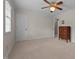 Bedroom with neutral carpet, ceiling fan and lighting, and an antique dresser with an adjacent doorway at 804 Warwick Ct, Burlington, NC 27215