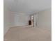Open bedroom with carpeted floors features a doorway to the bathroom, ceiling fan, and dual closets at 804 Warwick Ct, Burlington, NC 27215