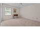 Cozy bedroom features neutral walls, carpeted floors, ceiling fan, and natural light from the window at 804 Warwick Ct, Burlington, NC 27215