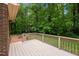 Back deck overlooking a lush backyard with mature trees, playground, and outdoor fire pit at 804 Warwick Ct, Burlington, NC 27215